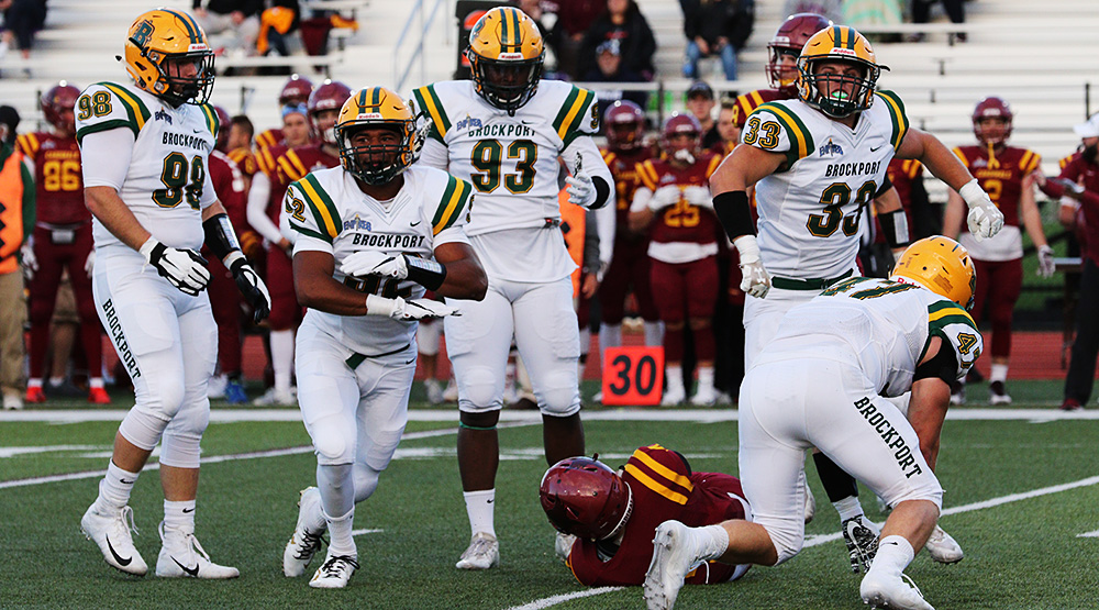 Brockport linebacker Tim Terry celebrates a tackle of a St. John Fisher player, along with defensive lineman John Tucci, left, defensive end Terry McDonald, linebacker Alex West and linebacker Matt Szymanski. (Brockport athletics file photo)
