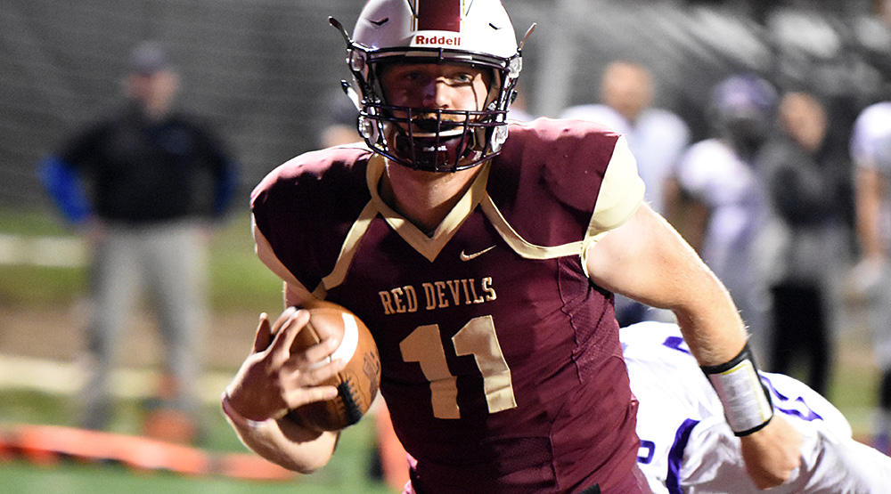 Eureka quarterback Drew Barth running, in a night game. (Eureka athletics photo)